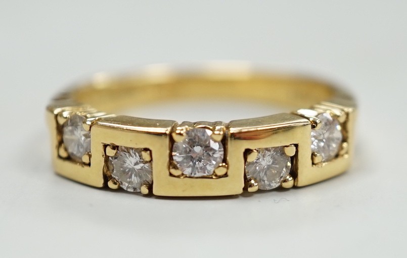A modern 18ct gold and five stone diamond set half hoop ring, size M/N, gross weight 4.9 grams.